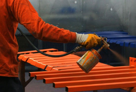 Metal painting worker in factory