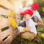 father and son diy painting fence
