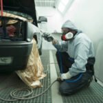 pro truck painter spray painting a truck