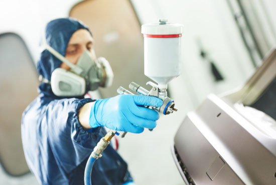 worker painting auto car bumper